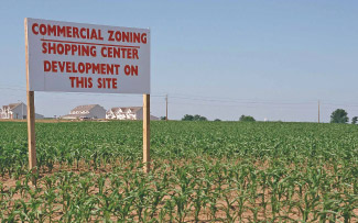 Commercial development sign in corn field.