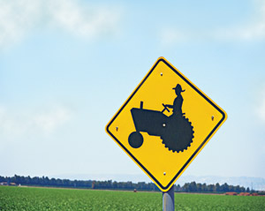 Tractor road caution sign, cover artwork for May 2006 Sound Consumer