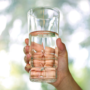 Hand holding a glass of water