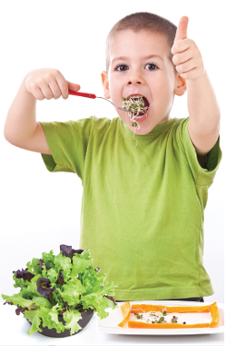 Child giving thumbs up to vegetables