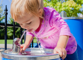 Child drinking at water fountain