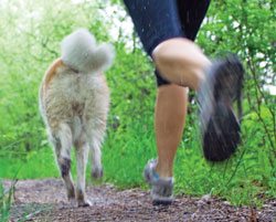 woman dog running park