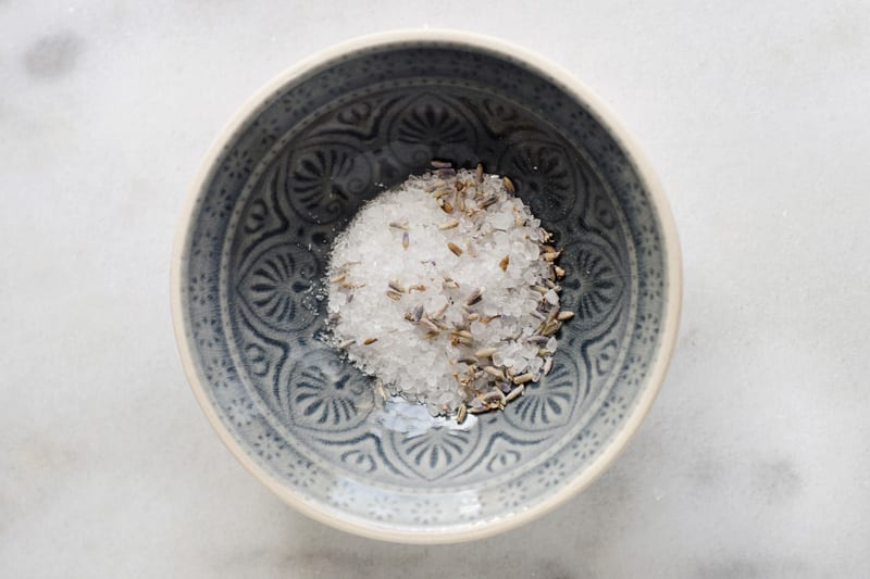 Salts and spices in a bowl on a countertop.
