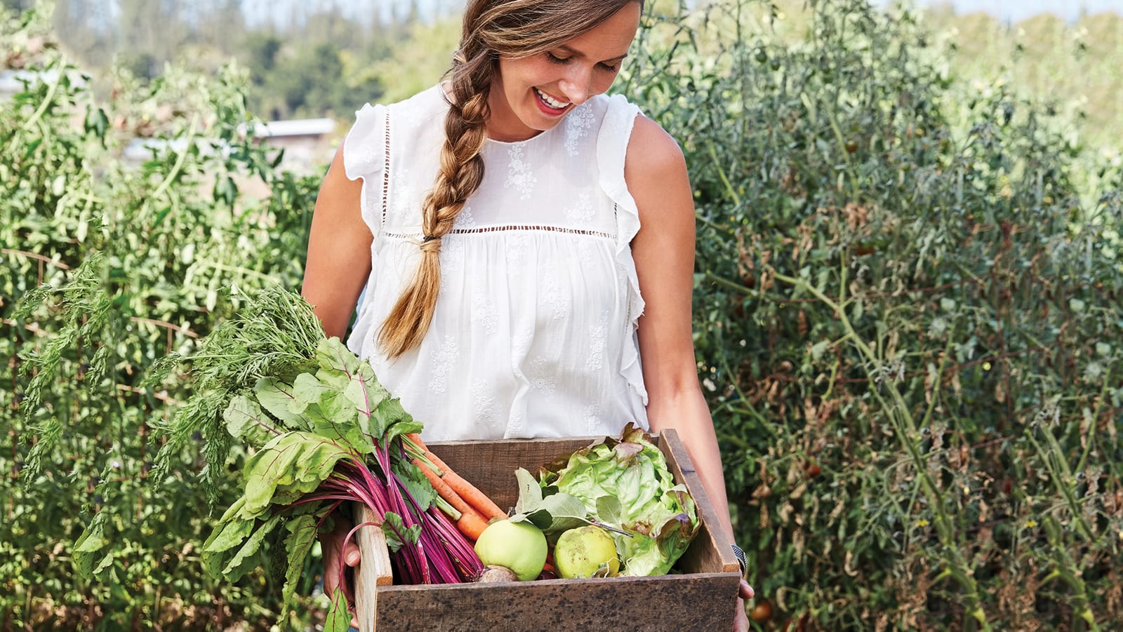 women holding vegetables in garden