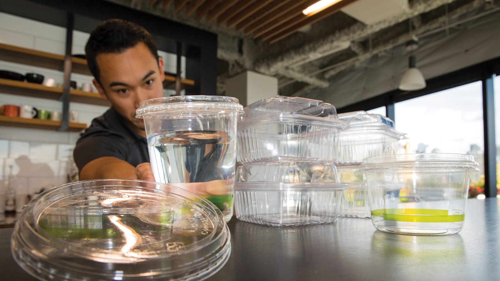 Brent Kawamura tests out compostable plastic containers