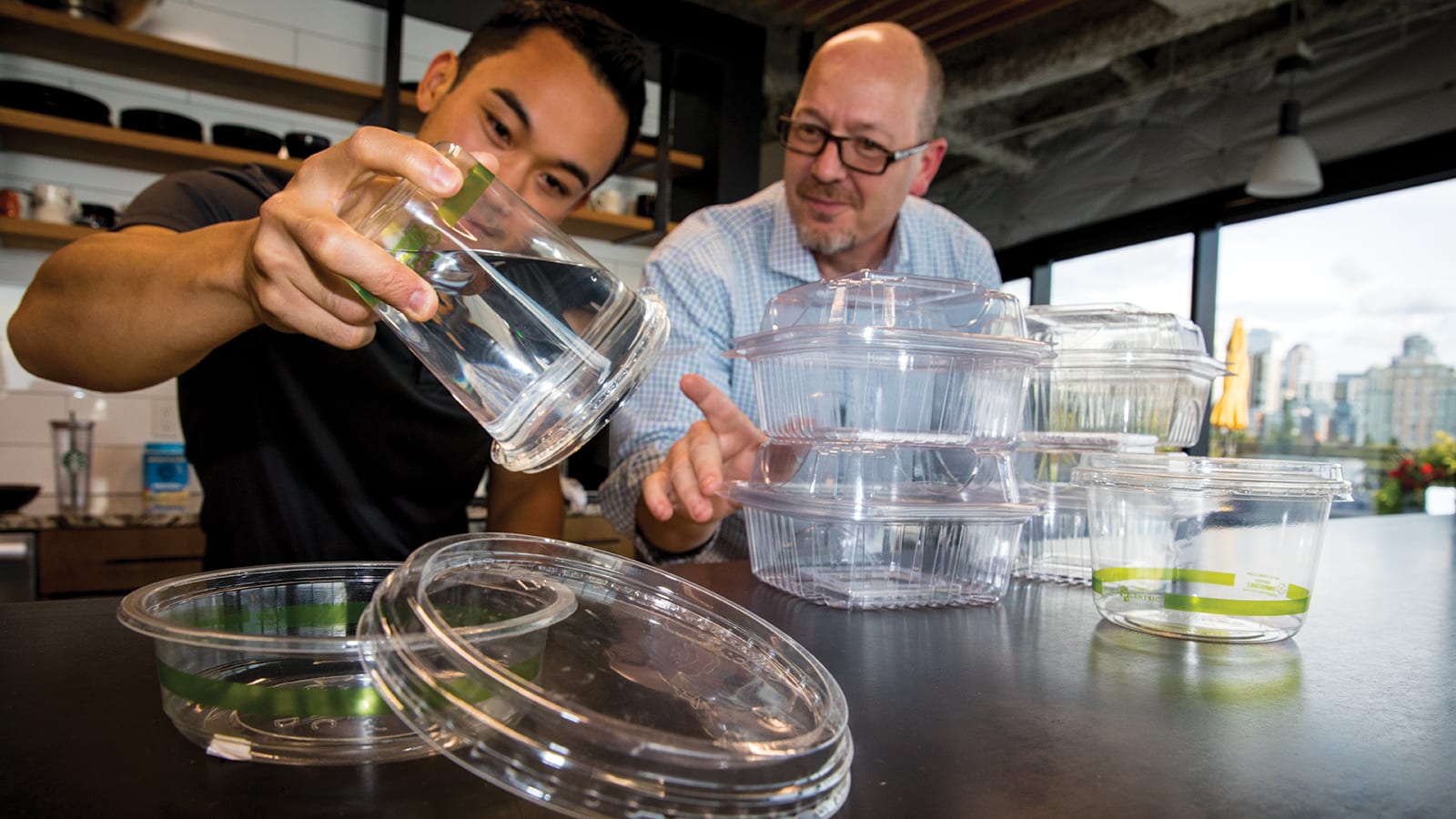 PCC’s senior sustainability specialist, Brent Kawamura, and senior deli merchandiser, Tracy Marik, analyze lid closure performance on new sustainable packaging options to check for leakage.