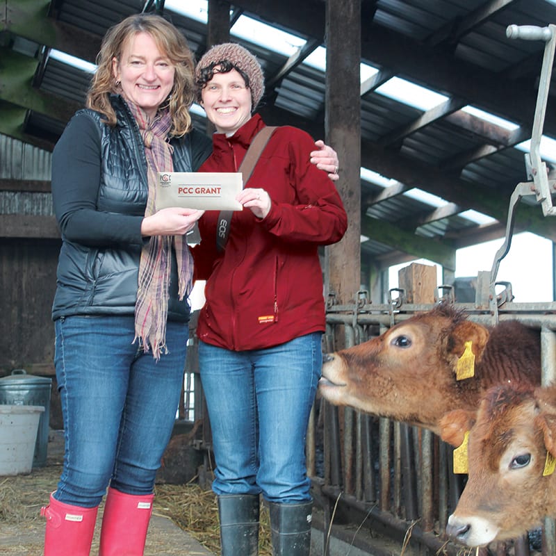 Pictured left to right: Celeste Coxen, Green Lake Village PCC store director, presents a grant to Jennifer McKeown for Mountains to Sound Greenway Trust.