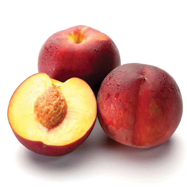 Nectarines on a white background. Cut in half.