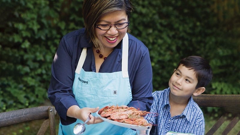 Hsiao-Ching Chou serving up food with her son