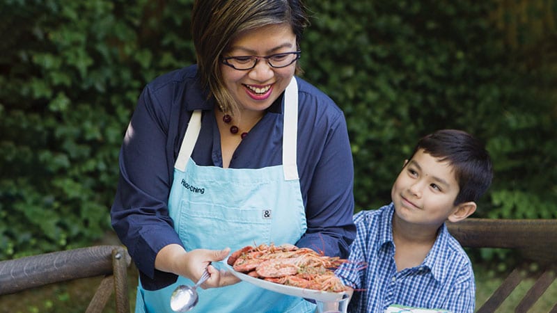 Hsiao-Ching Chou cooking preparing an outdoor feast. Photo credit: Clare Barboza/Sasquatch Books.