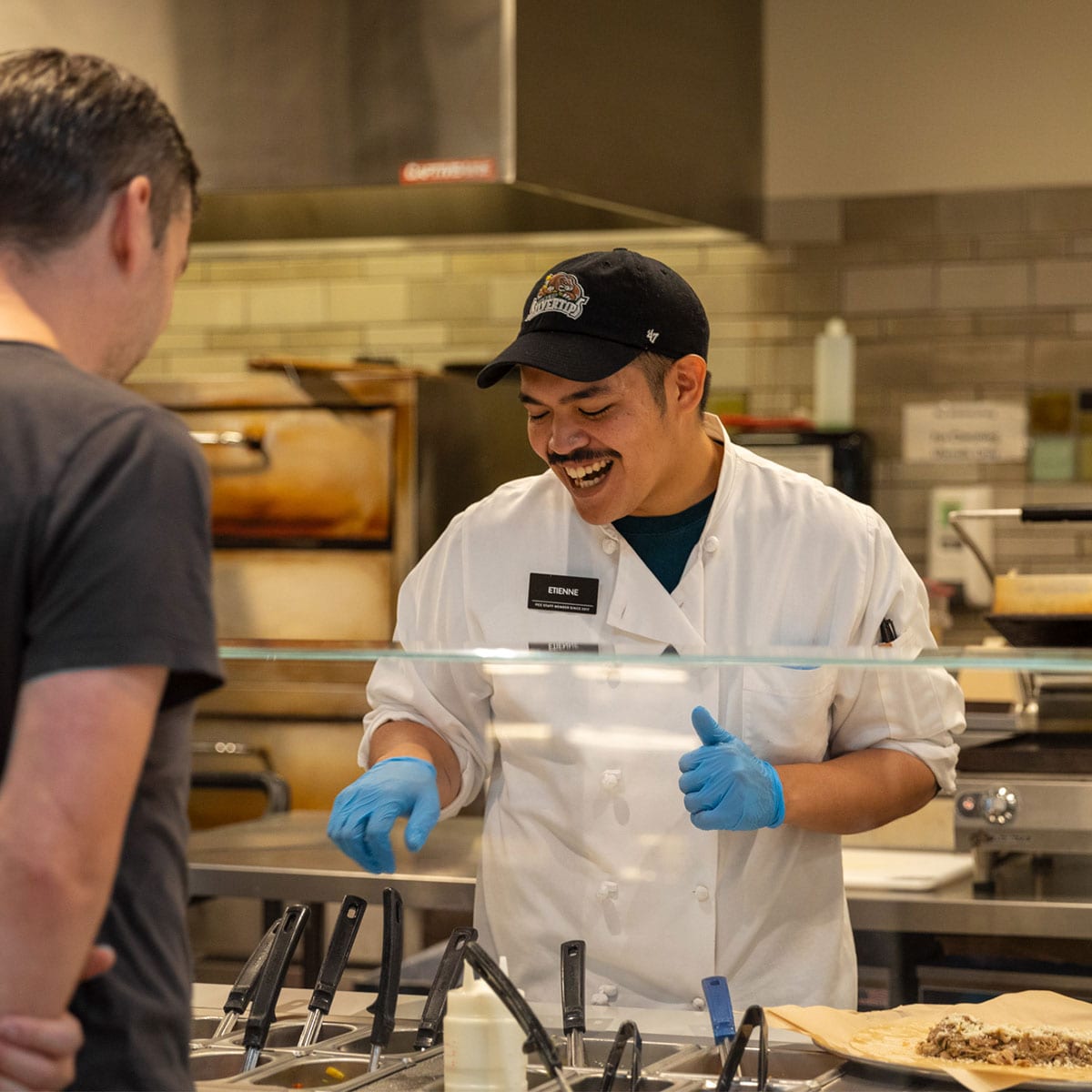 Persia smiling in front of flowers and window