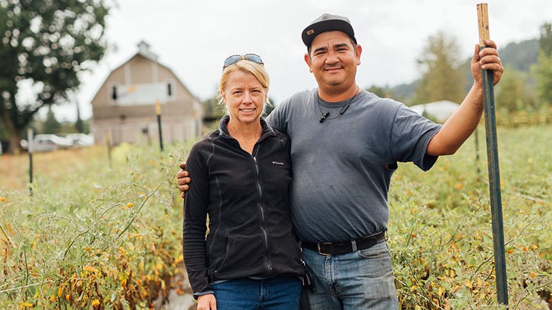 Owners of Four Elements Farm in front of their barn. Photo by Rylea Foehl courtesy of Pierce County Fresh.