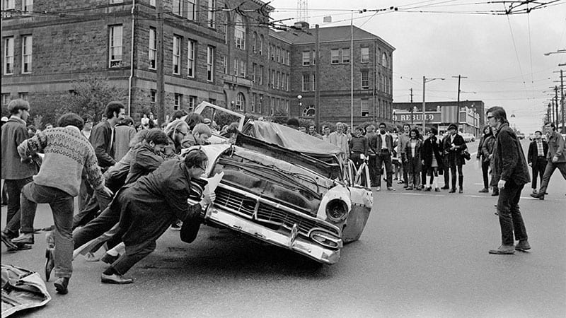 Students at Seattle Central Community College destroy an automobile as the symbol of air pollution