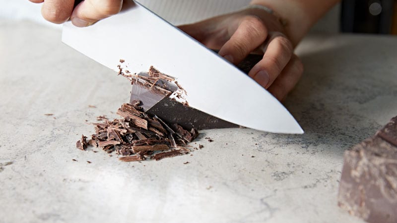person chopping chocolate