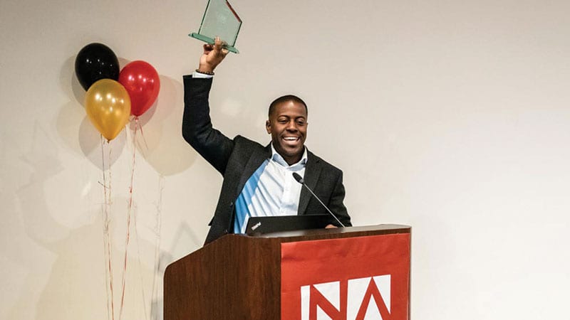 Edouardo Jordan accepting an award