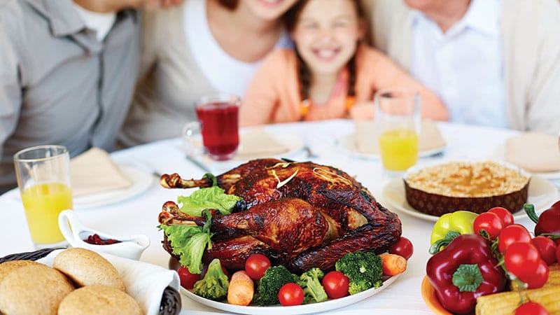 Family gathered around a healthy turkey meal