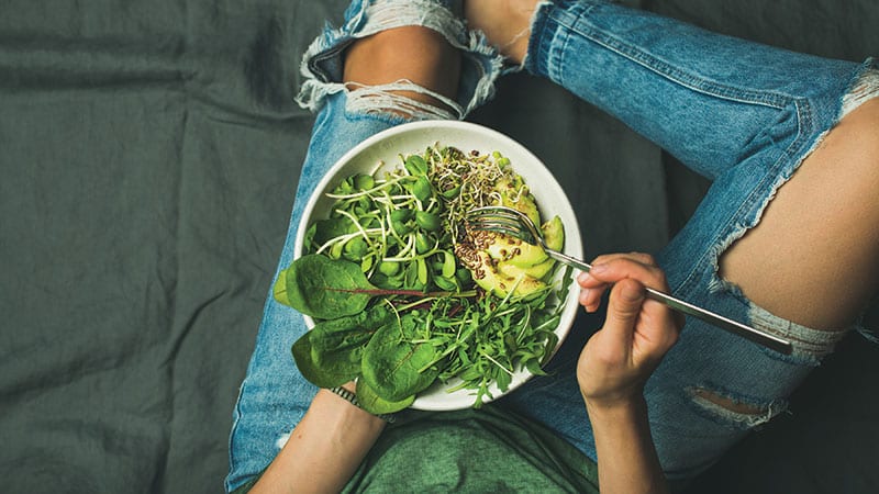 Young woman holding a Vegan mixed bowl