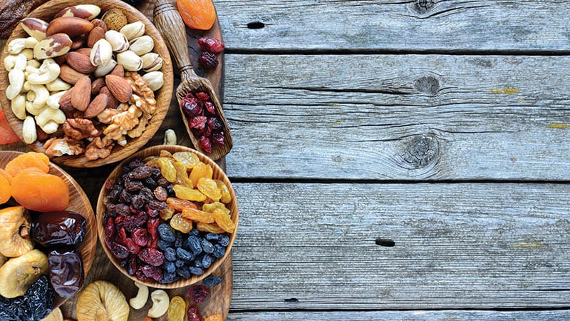 Bowls of fresh raw nuts and dried fruits