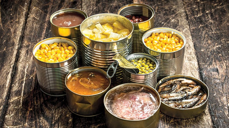 Open tin cans of various canned foods