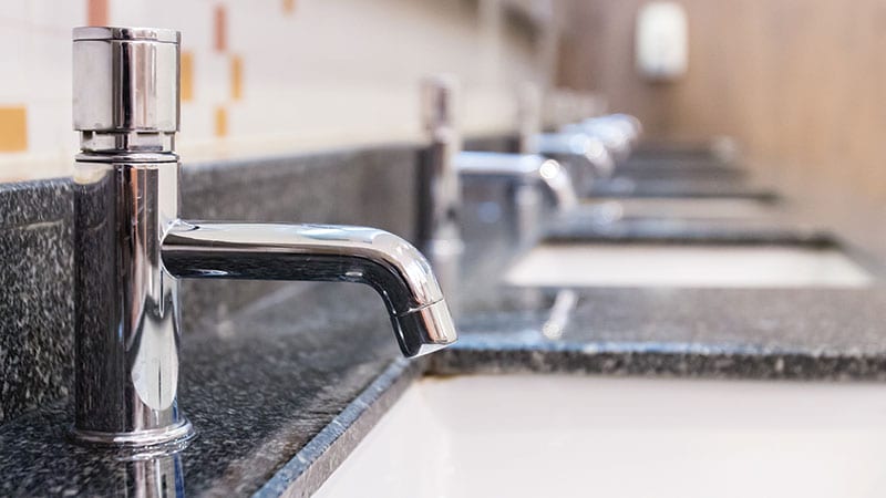 Rows of commercial faucets and sinks