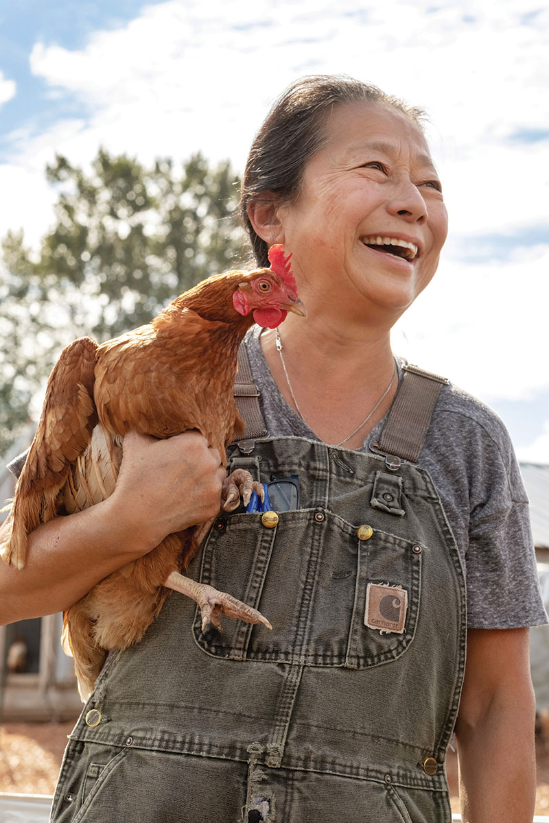 Woman holding chicken Vertical