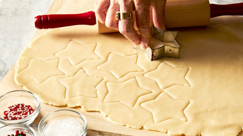 Fresh pasta being fed through a Kitchen Aid pasta attachment