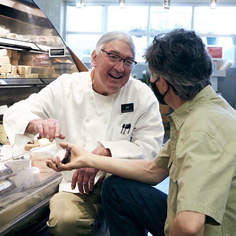 Jack talking cheese with a customer