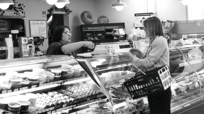 An employee at the deli counter helps a customer.