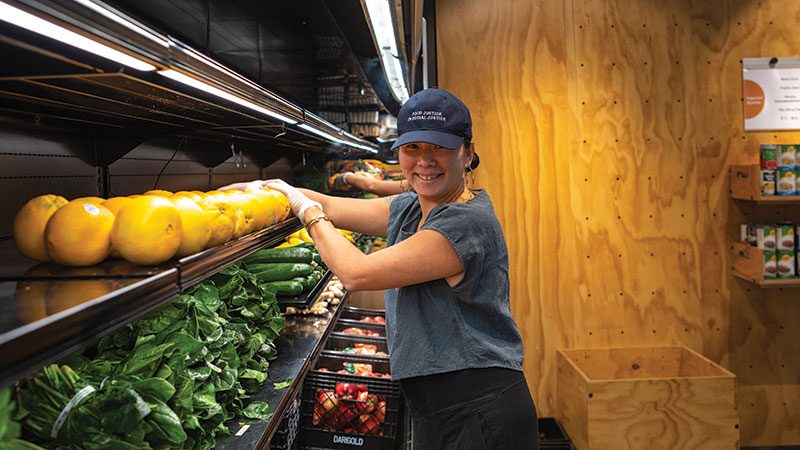Northwest Harvest employee stocking shelves