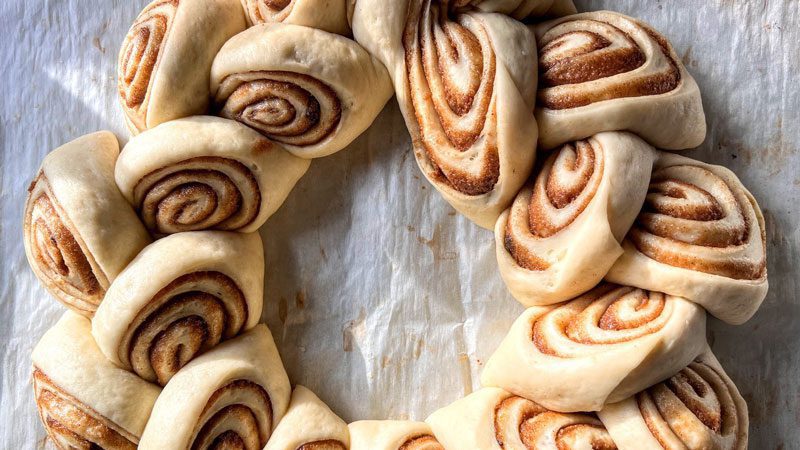 person rolling out dough