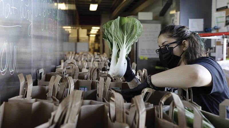 Lifelong volunteer bagging produce