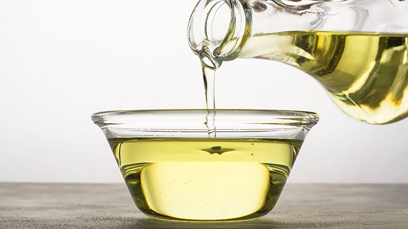Sunflower oil pouring into a bowl