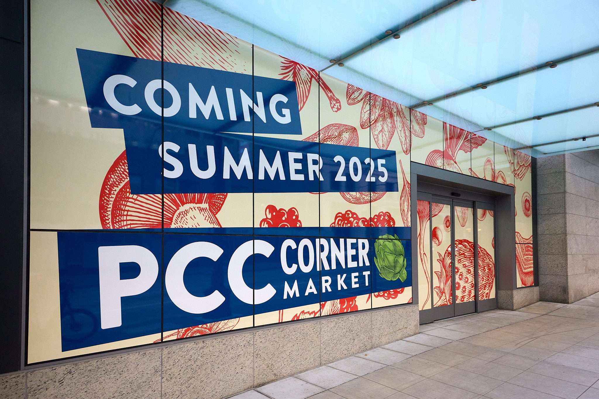 A banner downtown sharing that PCC Corner Market is coming Summer 2025.