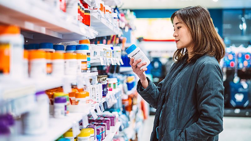 Woman reading RX labels