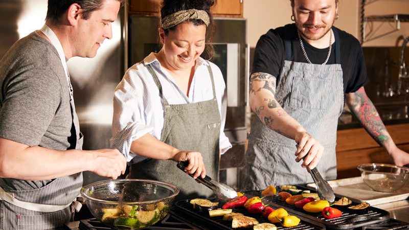 cooking class students cooking peppers