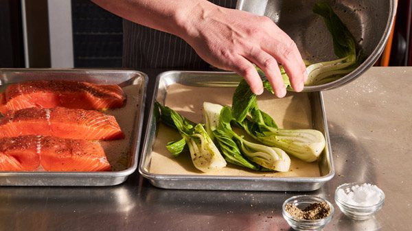 Chopped vegetables being tossed in oil.