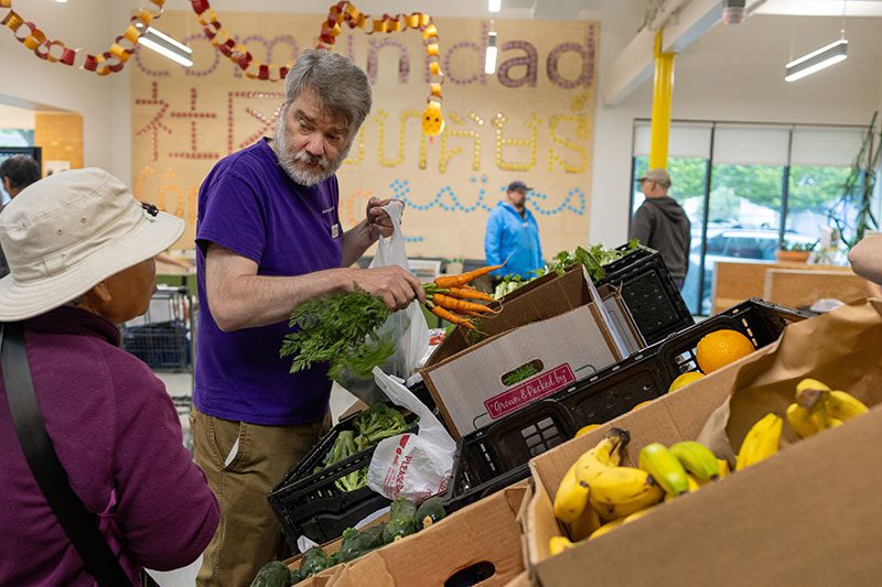 man holding carrots in a classroom